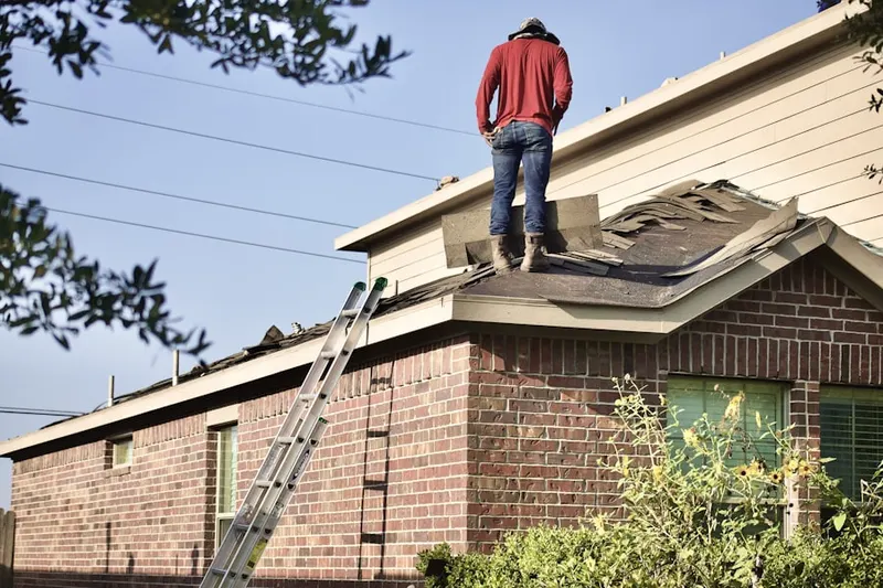 Professional roofer working on a residential roof in Antrim